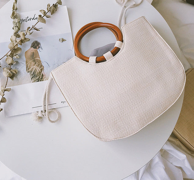 Straw handbag with wooden handle